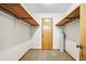 This closet features carpet, wooden shelves, and a wooden door at 50 Stonington Pl, Marietta, GA 30068