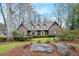 Charming brick home featuring a manicured front yard with mature trees and lush landscaping at 50 Stonington Pl, Marietta, GA 30068