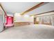 Spacious living room with neutral carpet, wood-paneled walls, and large window for natural light at 50 Stonington Pl, Marietta, GA 30068