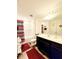 Bathroom featuring a shower-tub combo, dark wood cabinets and neutral countertops at 6408 Kennonbriar Ct, Lithonia, GA 30058