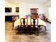 Well-lit dining room features a large wooden dining table and dark cabinets at 6408 Kennonbriar Ct, Lithonia, GA 30058