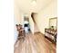 Spacious entryway featuring wood-look floors, a staircase, and a bookcase with a mirror at 6408 Kennonbriar Ct, Lithonia, GA 30058