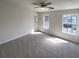 Bright bedroom with plush carpet and two large windows at 890 Abbotts Mill Ct # 75, Duluth, GA 30097