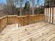 Wood deck with wooden railings and stairs surrounded by greenery, offering a serene outdoor living space at 890 Abbotts Mill Ct # 75, Duluth, GA 30097