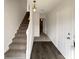 Inviting foyer with hardwood floors and a staircase leading to the upper level at 890 Abbotts Mill Ct # 75, Duluth, GA 30097