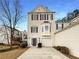 Charming beige two-story home with a bay window and a well-maintained front yard at 890 Abbotts Mill Ct # 75, Duluth, GA 30097