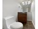 Half bathroom featuring a neutral vanity with dark countertop and hardwood-style flooring at 10067 Freeman Ct, Jonesboro, GA 30236