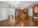 Open-concept kitchen with granite counters, wooden cabinets, and access to the living room at 10067 Freeman Ct, Jonesboro, GA 30236