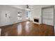 Bright living room featuring hardwood floors, a fireplace, and built-in shelving at 10067 Freeman Ct, Jonesboro, GA 30236