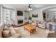 Staged living room featuring a fireplace, built-in shelving units, and neutral furnishings at 10067 Freeman Ct, Jonesboro, GA 30236