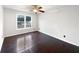 Bedroom with dark hardwood floors, a ceiling fan, and a bright window at 1525 Thornwood Dr, Jonesboro, GA 30236