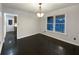 Bright dining room features hardwood floors, a modern light fixture, and a large window at 1525 Thornwood Dr, Jonesboro, GA 30236