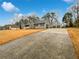 Long driveway leading to a well-maintained home with a detached garage at 1525 Thornwood Dr, Jonesboro, GA 30236