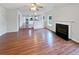 Open-concept living room featuring a fireplace, hardwood floors, and kitchen view at 1463 Wilson Manor Cir, Lawrenceville, GA 30045