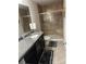 The bathroom is well appointed with granite countertop and new shower with seat at 3419 In Bloom Way, Auburn, GA 30011