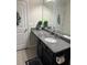 Bathroom vanity with a granite countertop, sink, mirror, and modern fixtures at 3419 In Bloom Way, Auburn, GA 30011