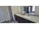 Elegant bathroom featuring double sinks with granite countertops, dark cabinetry, and a separate shower and tub at 3419 In Bloom Way, Auburn, GA 30011