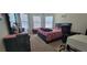This cozy bedroom features a large window for natural light, and comfortable carpet at 3419 In Bloom Way, Auburn, GA 30011