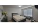 Bedroom with bed, window, and grey chaise lounge at 3419 In Bloom Way, Auburn, GA 30011