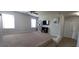 Inviting bonus room with windows, carpet, neutral walls, tv, and shelves at 3419 In Bloom Way, Auburn, GA 30011