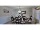 Bright dining area with a large dark wood table and seating for eight guests at 3419 In Bloom Way, Auburn, GA 30011
