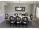 Elegant dining room featuring wainscoting, chandelier, and an eight place dining set at 3419 In Bloom Way, Auburn, GA 30011