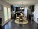 Well-appointed kitchen with dark cabinets, stainless steel appliances, and a dining area with lots of light at 3419 In Bloom Way, Auburn, GA 30011