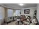 Living room with large windows, comfortable seating, and a decorative coffee table at 3419 In Bloom Way, Auburn, GA 30011