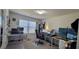 This is a home office with multiple screens, desks, and plenty of natural light at 3419 In Bloom Way, Auburn, GA 30011