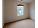 Clean bedroom with carpeted flooring and a window offering natural light at 4096 Mistymorn Ln, Powder Springs, GA 30127