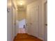 Upstairs hallway featuring hardwood floors and neutral paint, leading to other rooms at 4096 Mistymorn Ln, Powder Springs, GA 30127