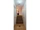 Hallway with stairs leading to upper level, featuring tile flooring at 4096 Mistymorn Ln, Powder Springs, GA 30127