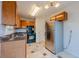 A modern kitchen with stainless steel refrigerator, wood cabinets, and black appliances at 4096 Mistymorn Ln, Powder Springs, GA 30127