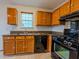 A well-maintained kitchen with wooden cabinets and a black stove at 4096 Mistymorn Ln, Powder Springs, GA 30127