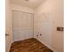 Clean laundry area with bi-fold doors and laminate flooring at 4096 Mistymorn Ln, Powder Springs, GA 30127