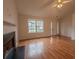 Bright living room featuring hardwood floors, a fireplace, and large windows at 4096 Mistymorn Ln, Powder Springs, GA 30127