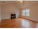 Bright living room featuring hardwood floors, a fireplace, and large windows at 4096 Mistymorn Ln, Powder Springs, GA 30127