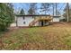 Exterior of home from back yard, showing wood deck and stairs that overlook the landscaped lawn at 3367 Spring Meadow Ct, Tucker, GA 30084