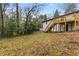 Exterior of home from back yard, showing wood deck and stairs that overlook the landscaped lawn at 3367 Spring Meadow Ct, Tucker, GA 30084