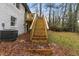 Exterior of home from back yard, showcasing wood deck and stairs leading to grass and landscaping at 3367 Spring Meadow Ct, Tucker, GA 30084