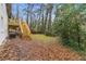 Exterior of home from back yard, showing wood deck and stairs that overlook the landscaped lawn at 3367 Spring Meadow Ct, Tucker, GA 30084