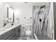 A contemporary bathroom with double vanity, sleek gray cabinets, black hardware, and luxurious walk-in shower at 3367 Spring Meadow Ct, Tucker, GA 30084