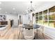 Dining area with a modern light fixture and a large window offering a view of the outdoors at 3367 Spring Meadow Ct, Tucker, GA 30084