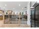 Modern entryway featuring a black front door, wood floors, and an open view to the kitchen at 3367 Spring Meadow Ct, Tucker, GA 30084