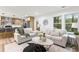 Cozy living room with neutral furniture, a stylish rug, and an adjacent modern kitchen at 3367 Spring Meadow Ct, Tucker, GA 30084