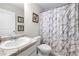 Cozy bathroom with a marble patterned shower curtain, a sink with granite countertops, and neutral walls at 461 Charleston Pl, Villa Rica, GA 30180