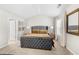 Comfortable bedroom features a plush tufted gray headboard, neutral walls, carpeted floor, and ample natural light at 461 Charleston Pl, Villa Rica, GA 30180