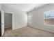 Neutral bedroom with two windows and carpet flooring at 461 Charleston Pl, Villa Rica, GA 30180