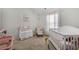 Bright Bedroom featuring white furniture, pink accents, and a large window for plenty of natural light at 461 Charleston Pl, Villa Rica, GA 30180