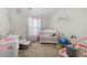 Bright Bedroom featuring neutral walls, carpeted floor, a crib, and a changing table at 461 Charleston Pl, Villa Rica, GA 30180